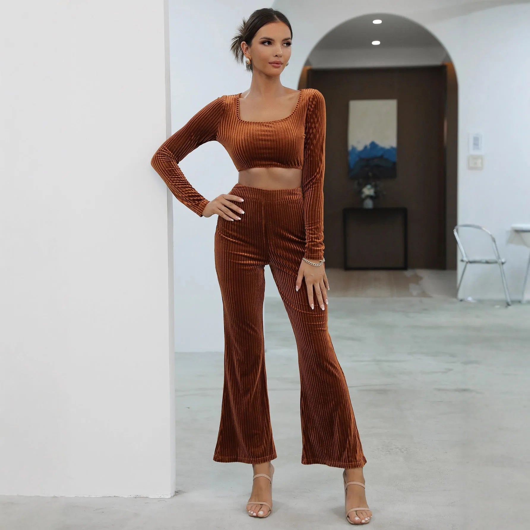 Caramel coloured long sleeve sweater and trouser set laid flat, showing casual two-piece design.