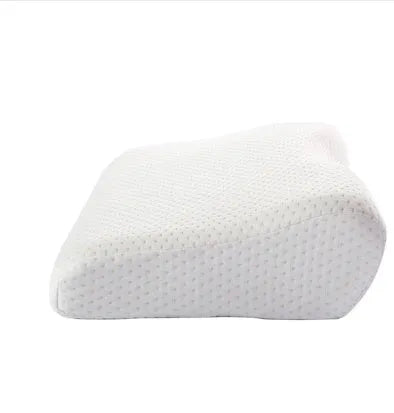 Butterfly-shaped blue memory foam cervical pillow on a bed.