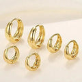 Three pairs of gold electroplated copper earrings with geometric ring design on a white background