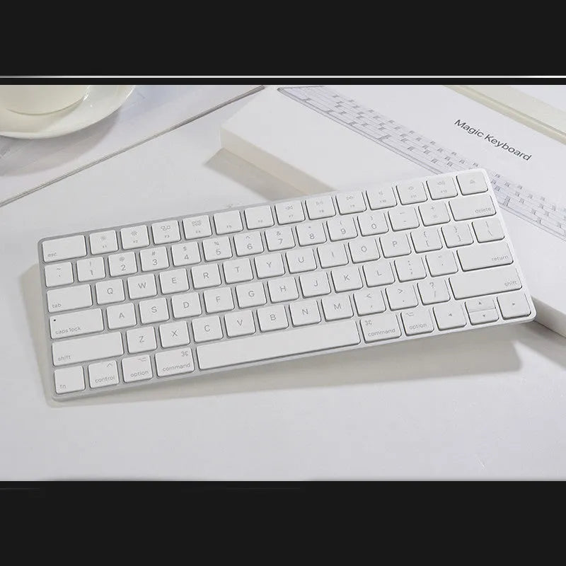 White Apple Bluetooth wireless keyboard with ultra-thin metal casing on a desk