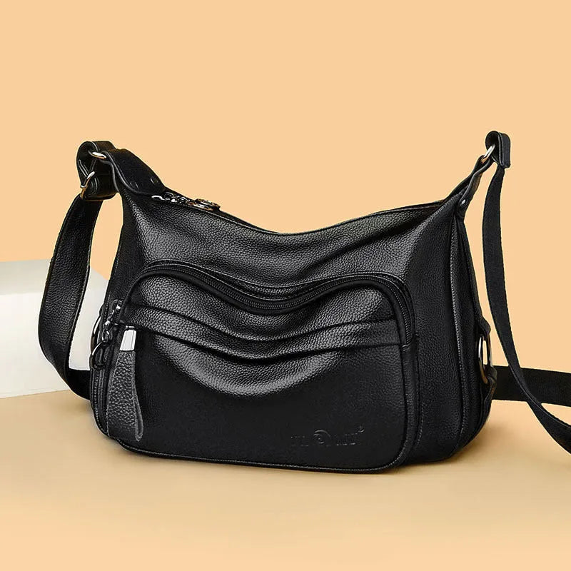 Large black women's crossbody shoulder bag with multiple internal compartments and zip closure