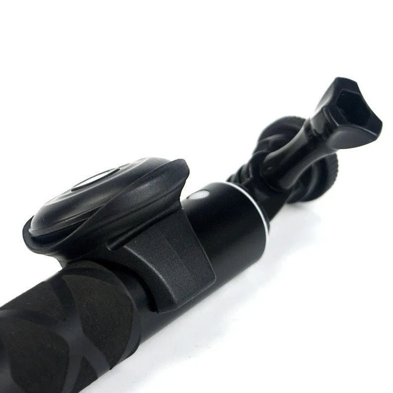 Small black Snap Bluetooth remote shutter on a hand, showing single button.