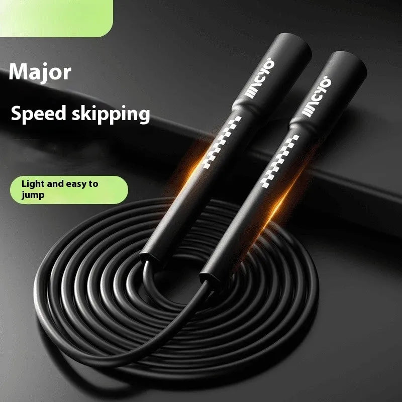 Colourful PVC fitness skipping rope for physical exercise on a plain background