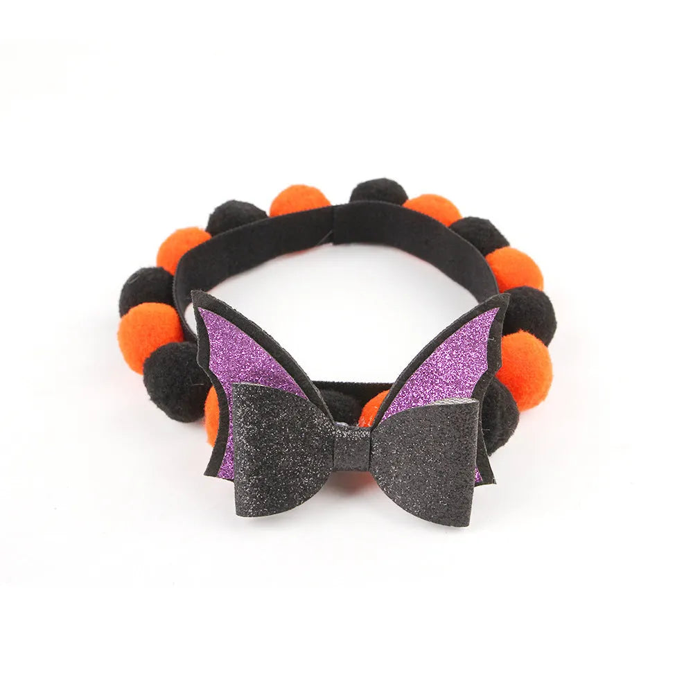 Halloween pet collar with a fur ball decoration in a pumpkin design, shown in size M.
