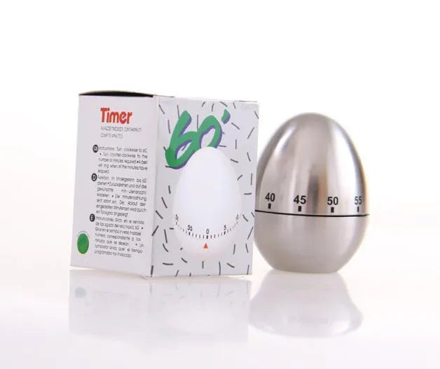 Stainless steel egg-shaped mechanical kitchen timer on a kitchen countertop