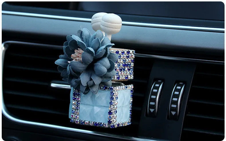 Car flower outlet perfume air freshener in white colour clipped to vehicle air vent, 3.2cm x 7cm size