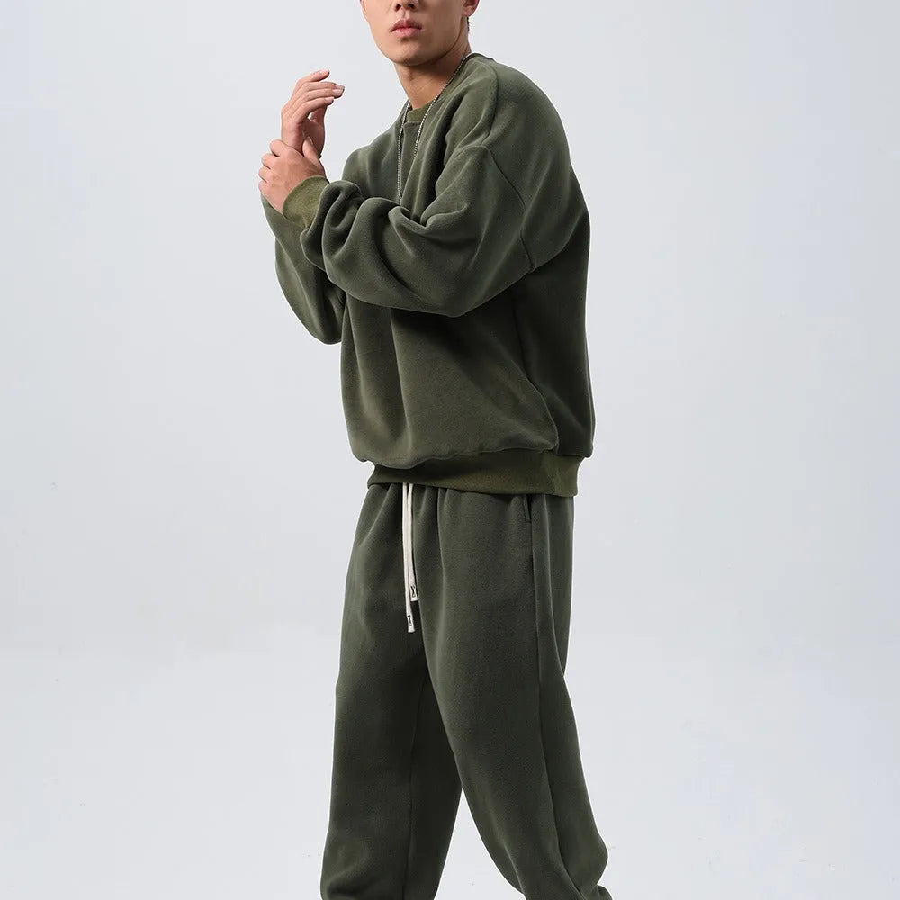 Men's black polar fleece sports suit set with long sleeve coat and loose trousers on a hanger.