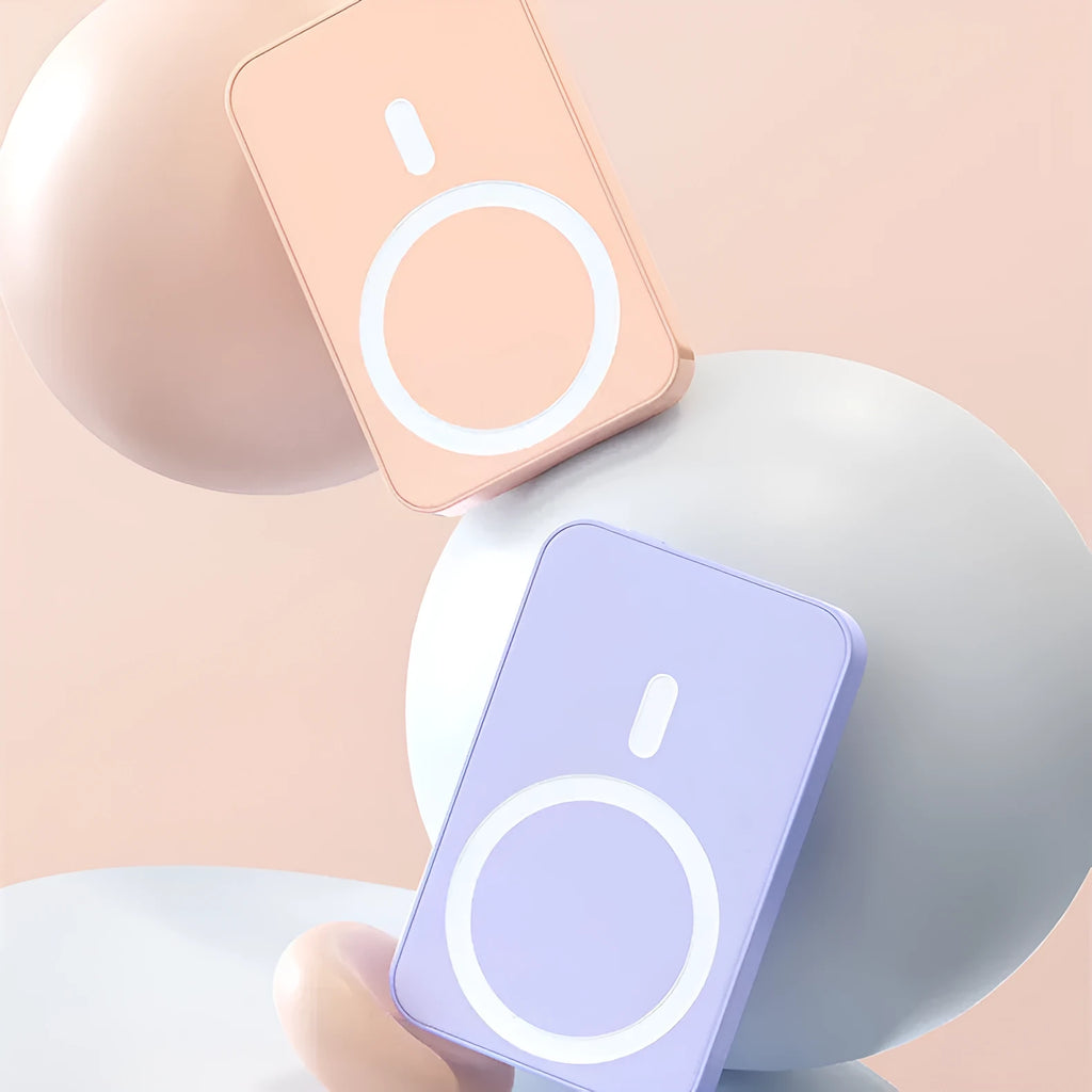 Pink magnetic wireless power bank on a table showing its compact size and charging surface.