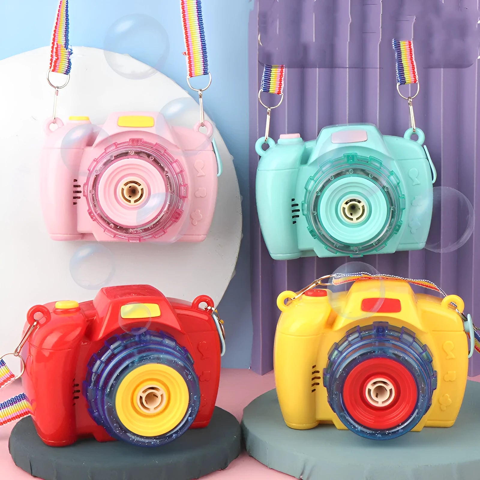 Yellow camera-shaped automatic bubble blowing toy for children on a green background.