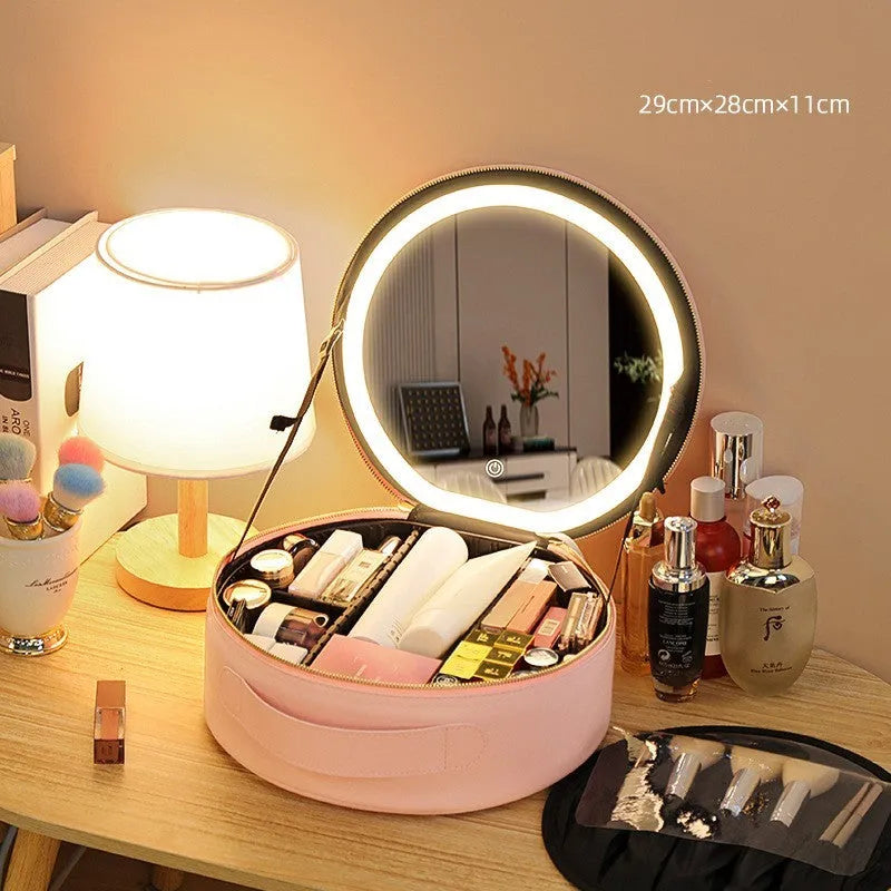 Round pink PU leather makeup bag open showing illuminated mirror and internal partitions.