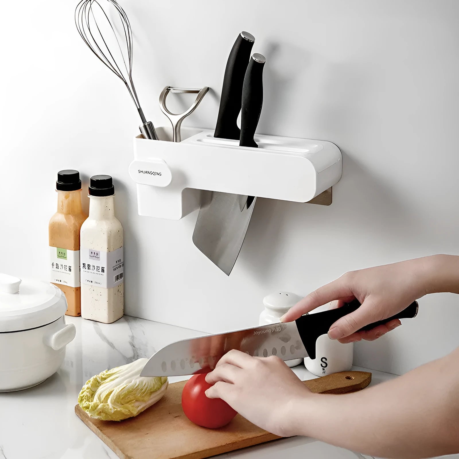 White plastic kitchen knife storage rack with compact dimensions on kitchen worktop