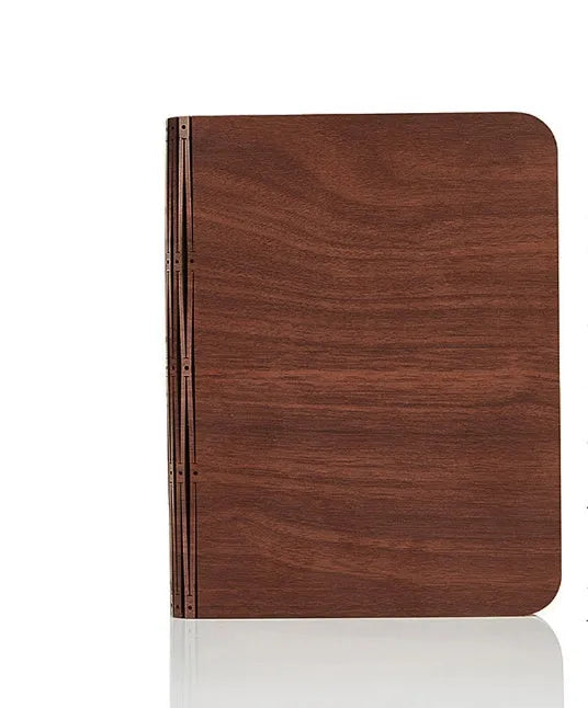Solid wood USB-powered book light in three sizes on a desk with a book.