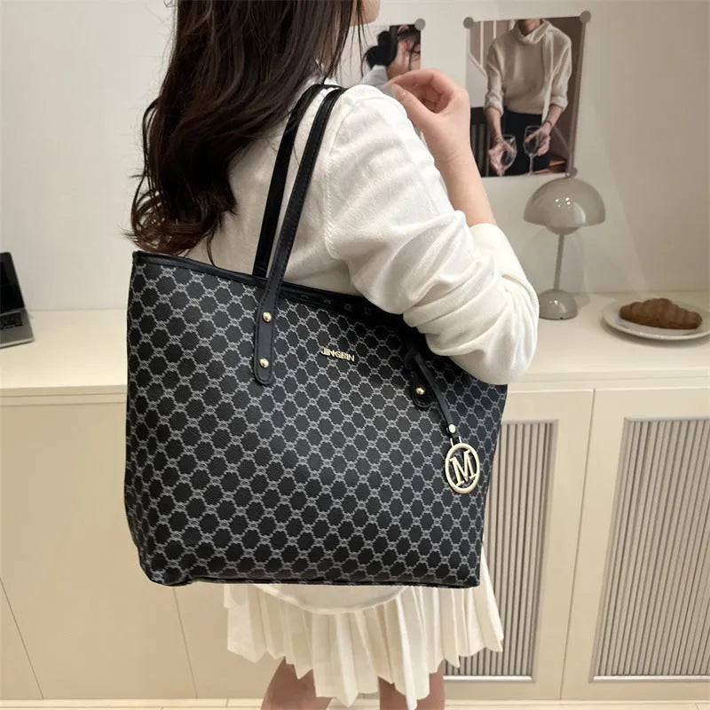 Large black PU leather shoulder bag with sewn thread detailing on a white background.