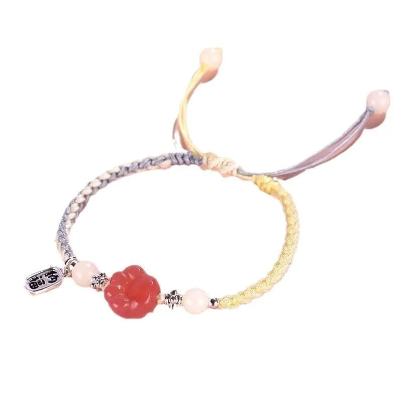 Red cat's paw charm couples bracelet with pink woven base, handmade glass and glaze jewellery