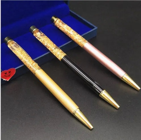 Gold foil metal ballpoint pen 13.8cm with 1mm tip on white background