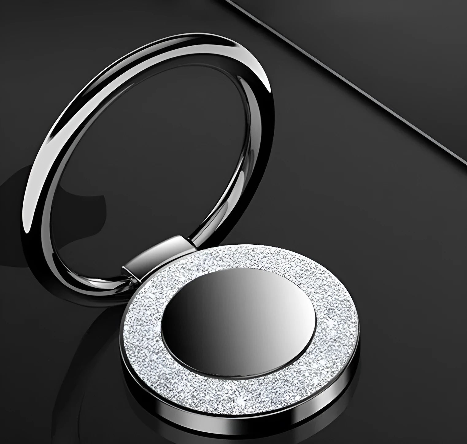 Sparkling bling glitter metal phone holder ring showing rotation, attached to a smartphone.