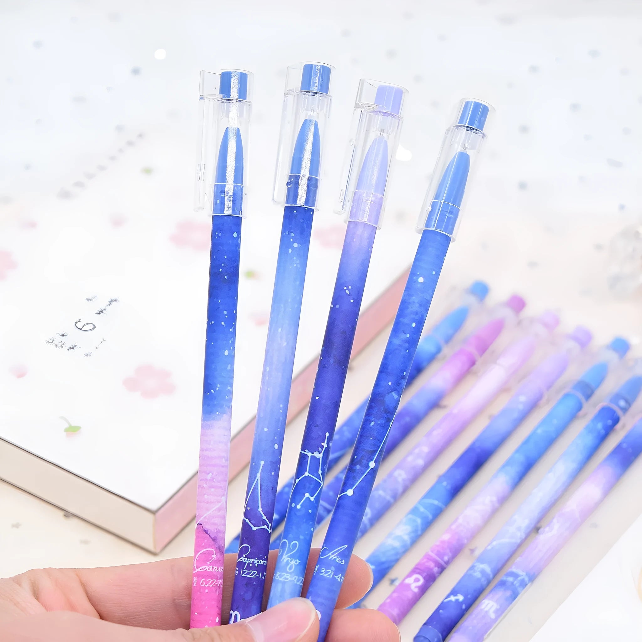 Box containing 12 assorted quick-drying gel pens with 0.5mm fine tips on a white background.