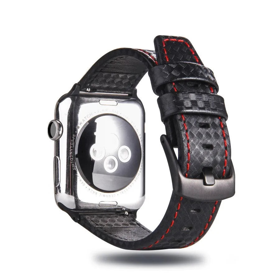 Leather and carbon fibre Apple Watch strap with red stitching next to a black PC case with carbon fibre pattern.