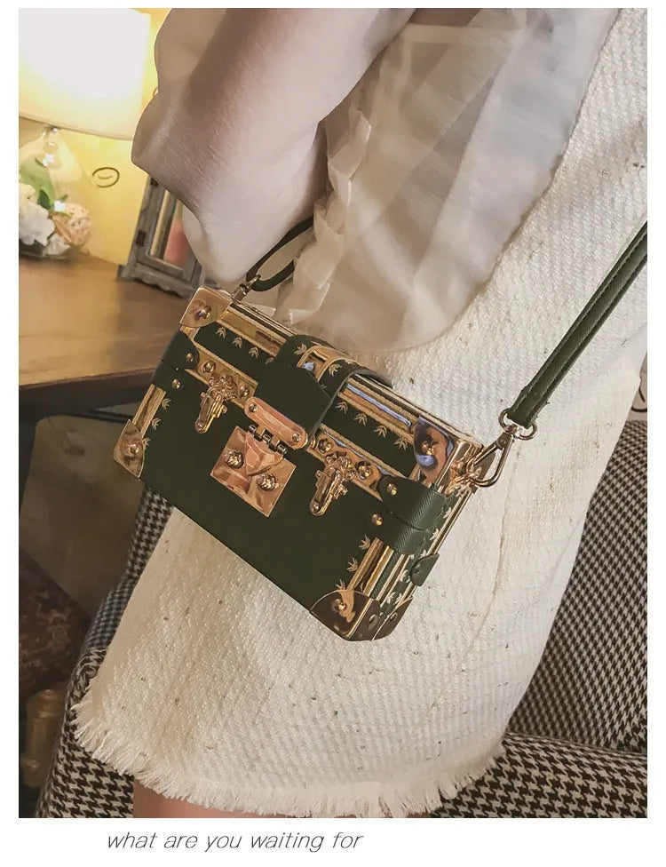Hard PU women's shoulder bag in black with flap closure, rivet detail, and adjustable strap.