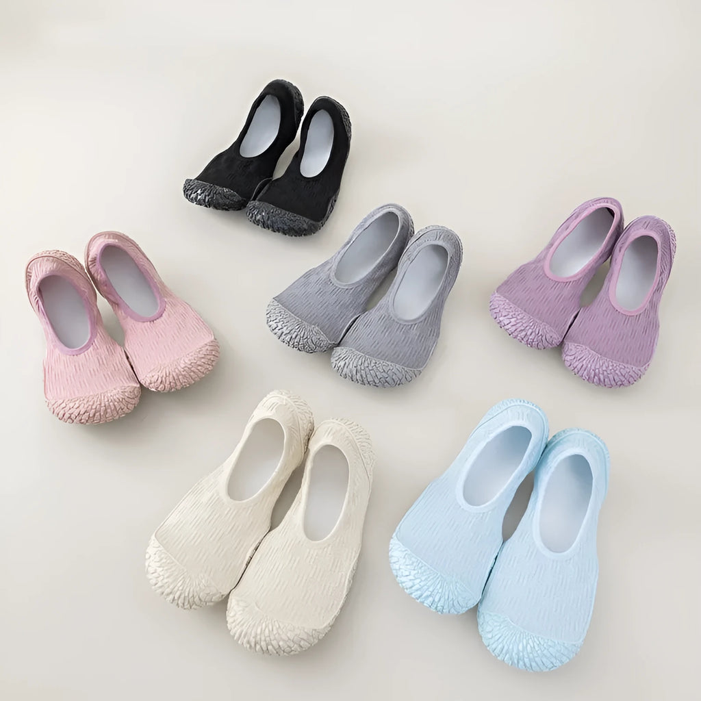 Women's low-top indoor fitness shoe in beige with a soft rubber sole and mesh lining.