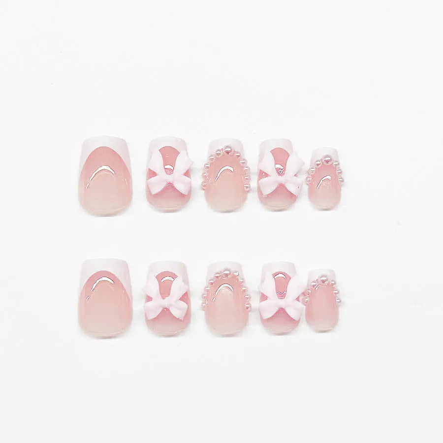 Set of 24 short square nail wraps with French tips and bow, tulip, and starry sky designs on a backing card.