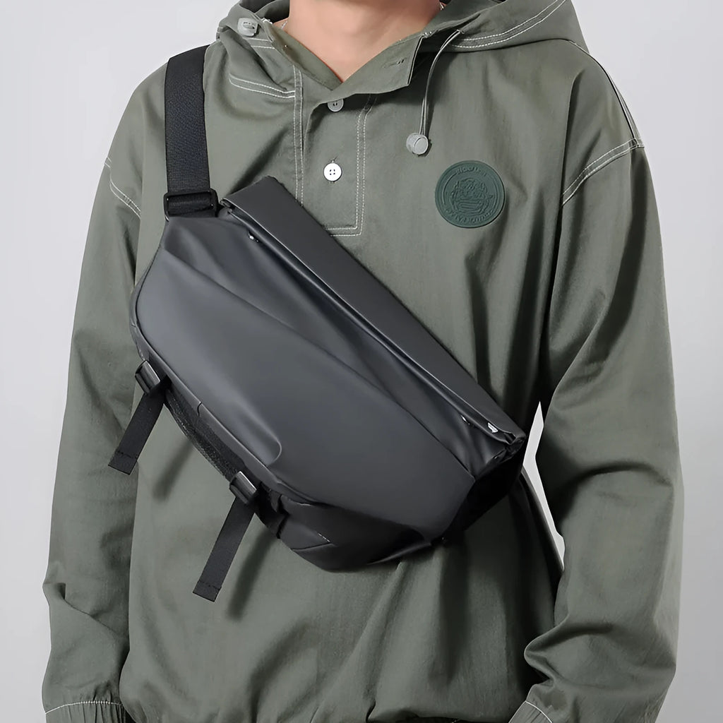Grey men's crossbody sling backpack made of PU with a zipper and patch pocket.