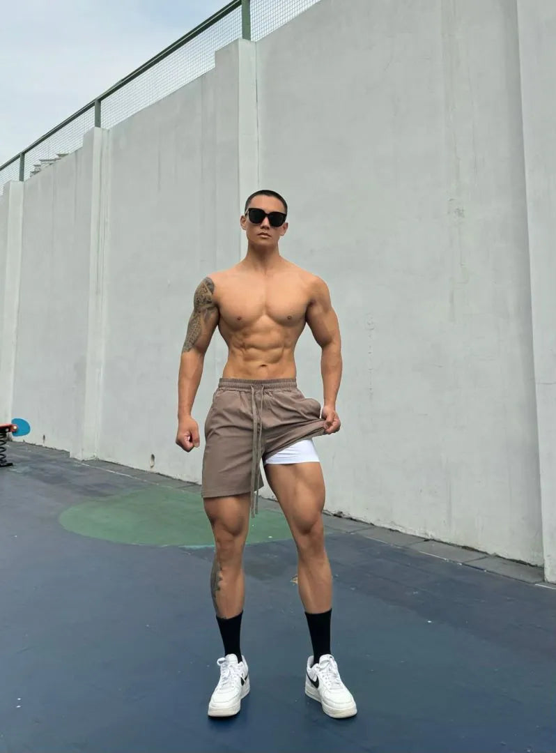Men's ice silk quick-drying double-layer casual shorts in black, shown on a model.