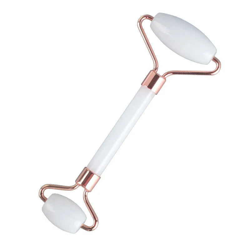 White jade double-headed facial roller and gua sha scraping tool set on a storage board.