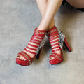 Black fish mouth Roman block heel high-top shoes with snake skin texture and a thick rubber sole.