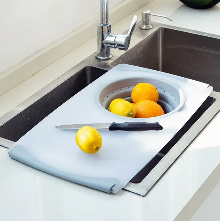 Grey folding chopping board with detachable drain basket showing 50cm cutting surface