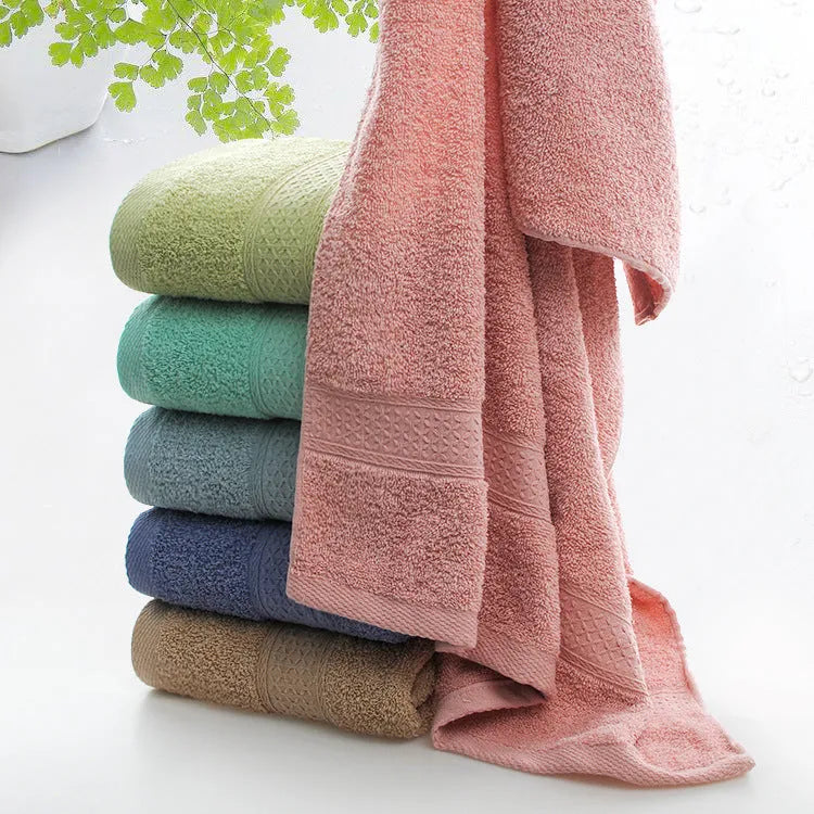 Thick bath and beach towels in seven colour options including apple green, dark blue, and light pink