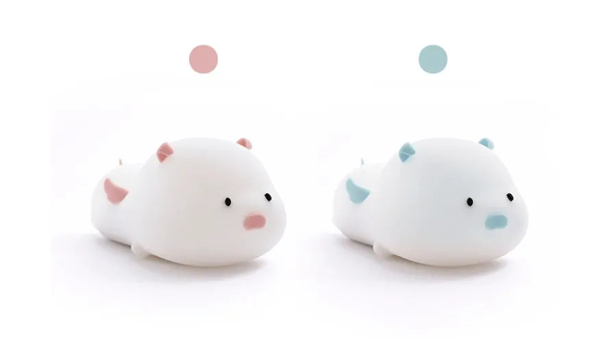 Blue or pink pig silicone night light with sleeping design, shown with dimensions and rechargeable battery.