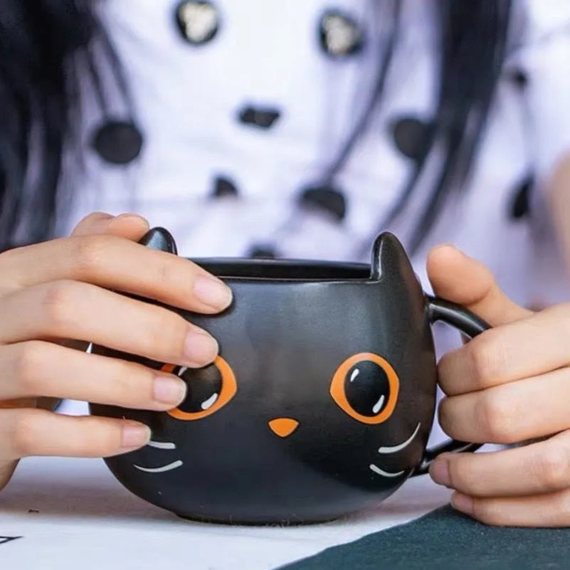 Black ceramic cat-shaped mug with pumpkin decoration and optional spoon lid, 355ml capacity.