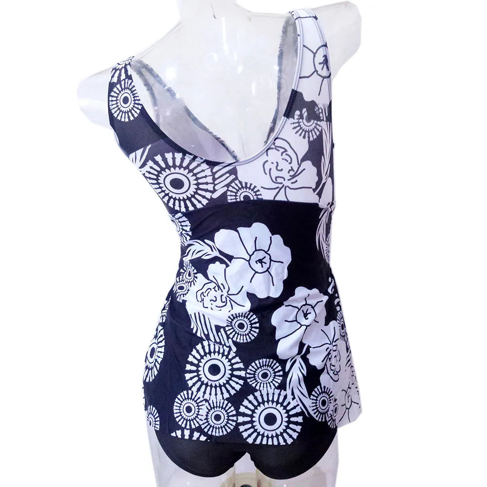 Plus-size one-piece swimsuit in black with floral print and soft bust support, front view