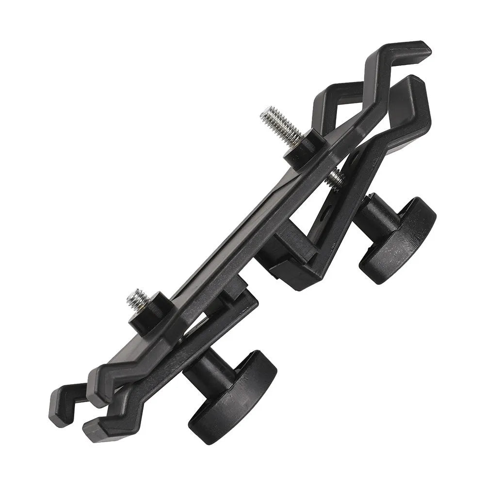Black ABS plastic umbrella clip mounted on a camera tripod head.