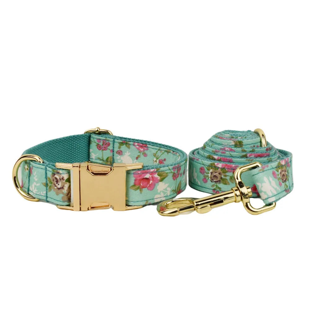 Four-piece dog accessory set with rose print bow, green fabric collar, leash and vest