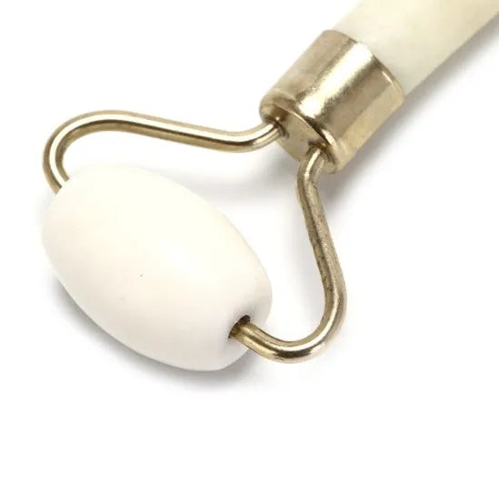 Natural jade facial massage roller on a light background showing smooth green stone and handle