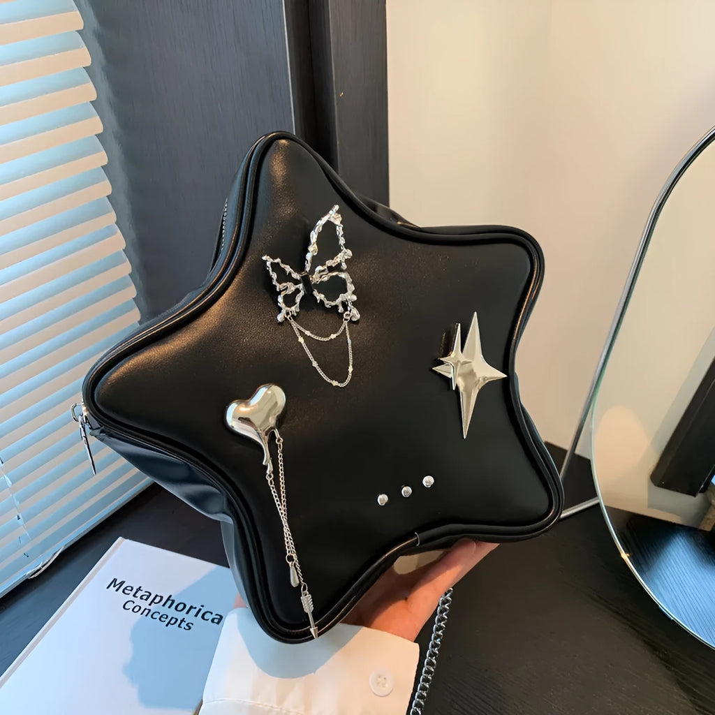 Black soft PU street-style backpack with metal star and butterfly pendants, chain trim, and multiple pockets.