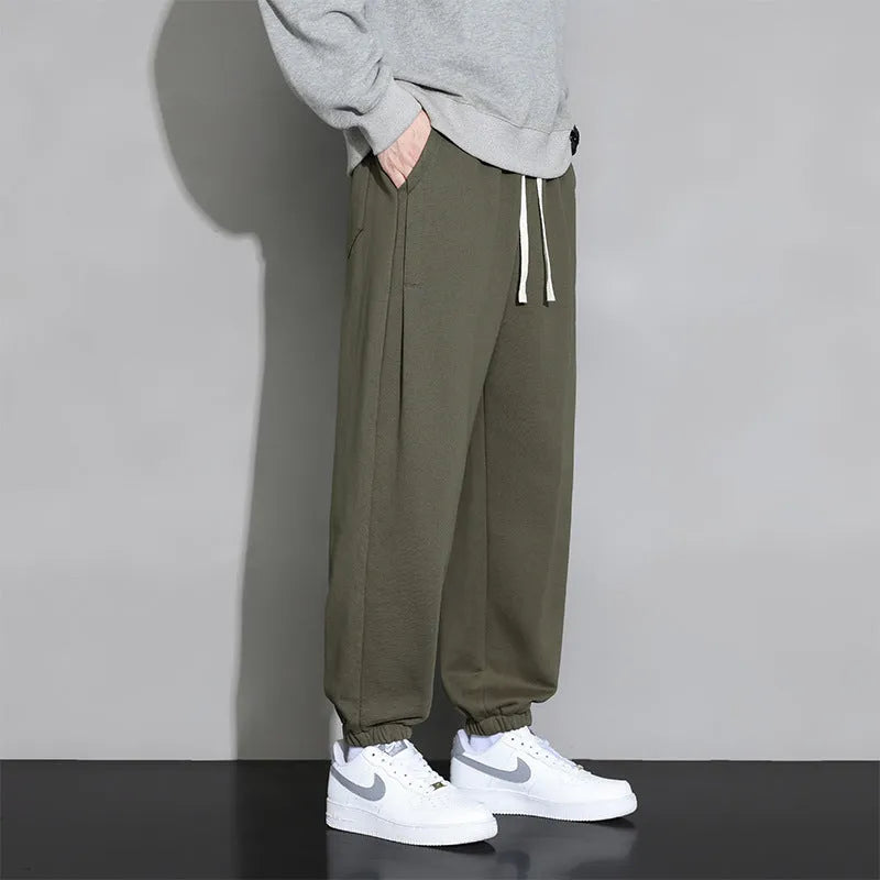 Men's loose fit grey sports trousers with drawstring waist and cotton-polyester blend fabric