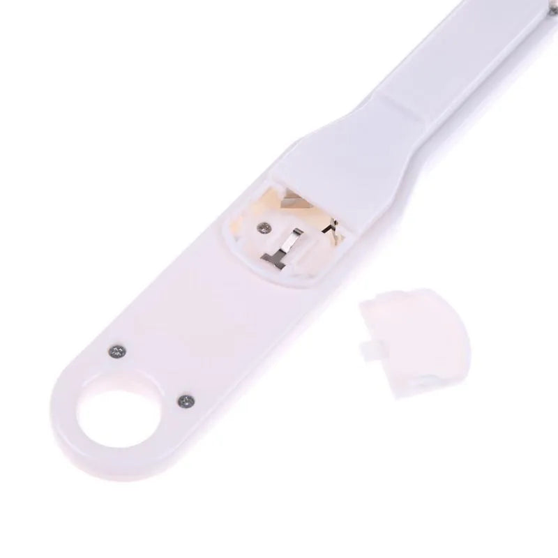 White digital spoon kitchen scale with LCD screen showing weight measurement.