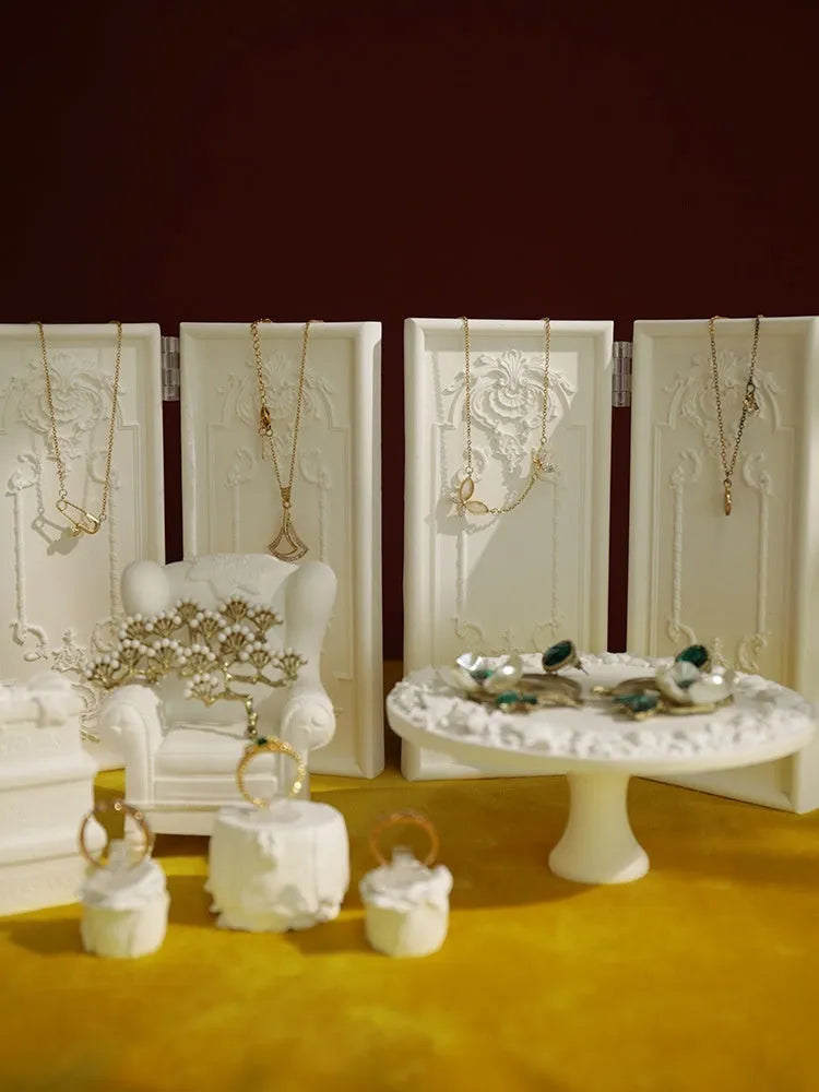 White plaster retro jewellery display stand with three layers, neutral background for necklace display