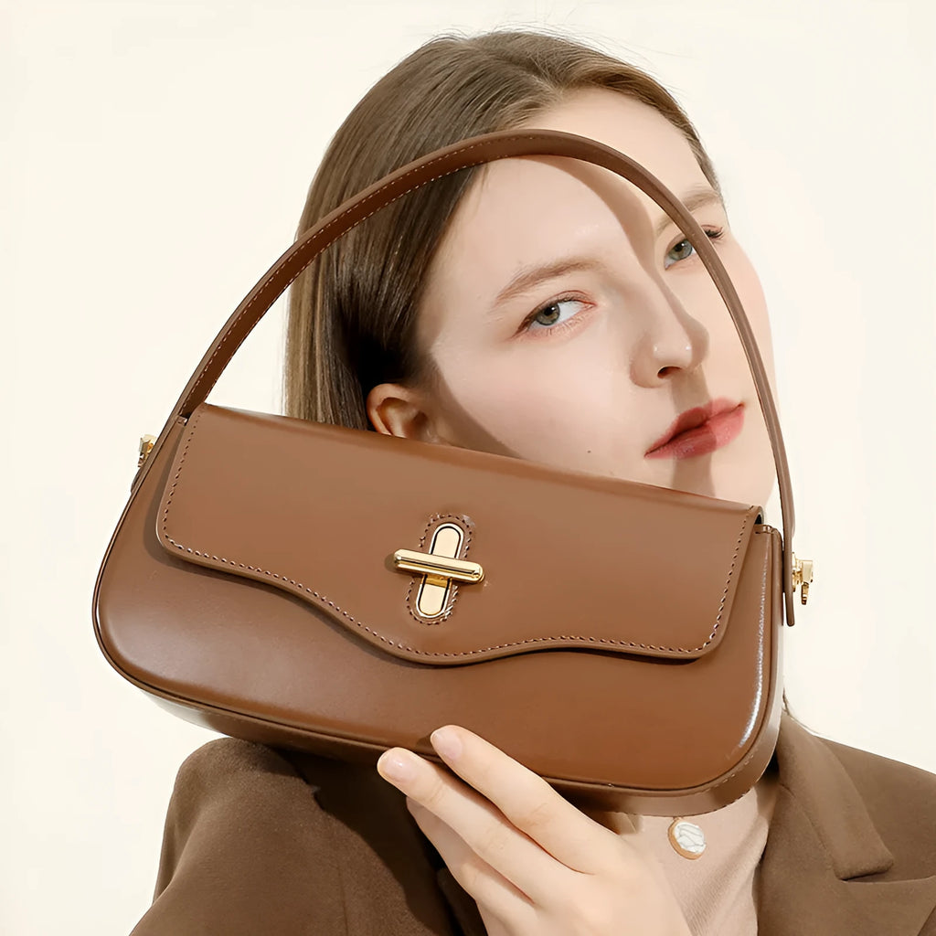 Genuine leather women's baguette handbag with lock detail and double shoulder straps