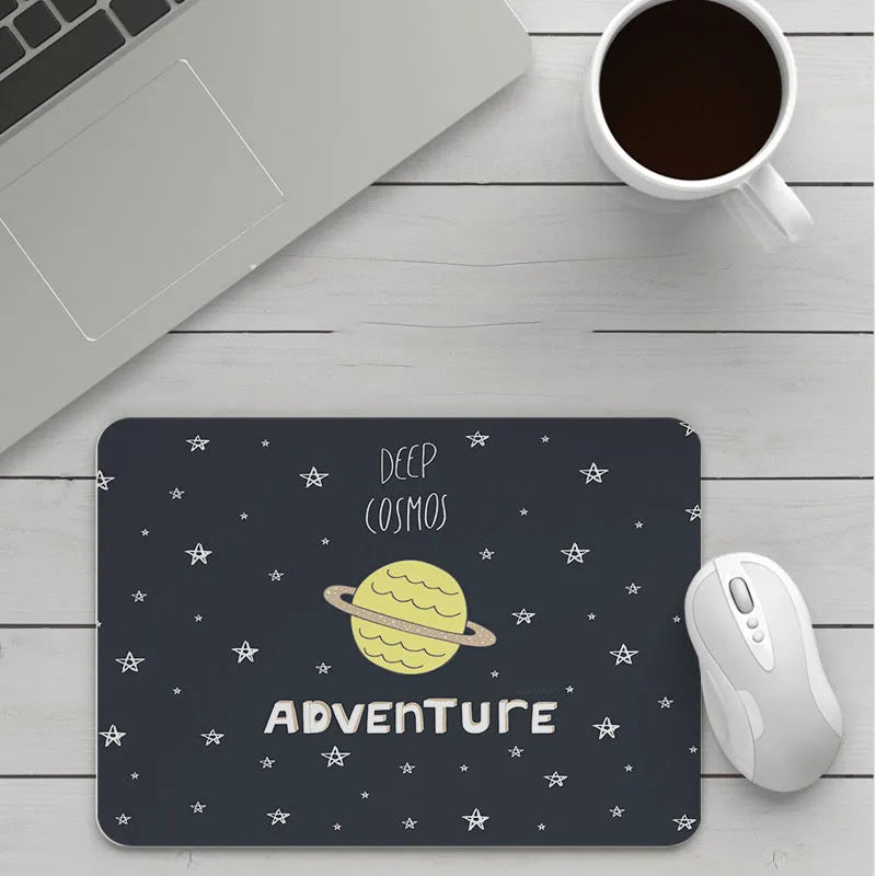 Thick custom cartoon mouse pad with colourful design on a desk, showing black seam edge