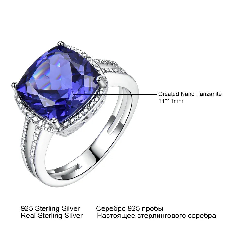 A blue tanzanite stone set in a sterling silver women's ring on a white background.