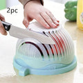 Blue salad cutter bowl with chopper lid and serving plate base for vegetable preparation
