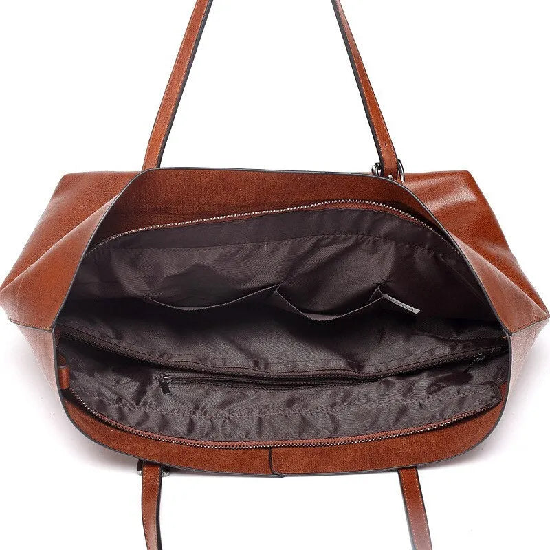 Brown waxed cowhide leather women's crossbody handbag with a structured shape and a front flap.