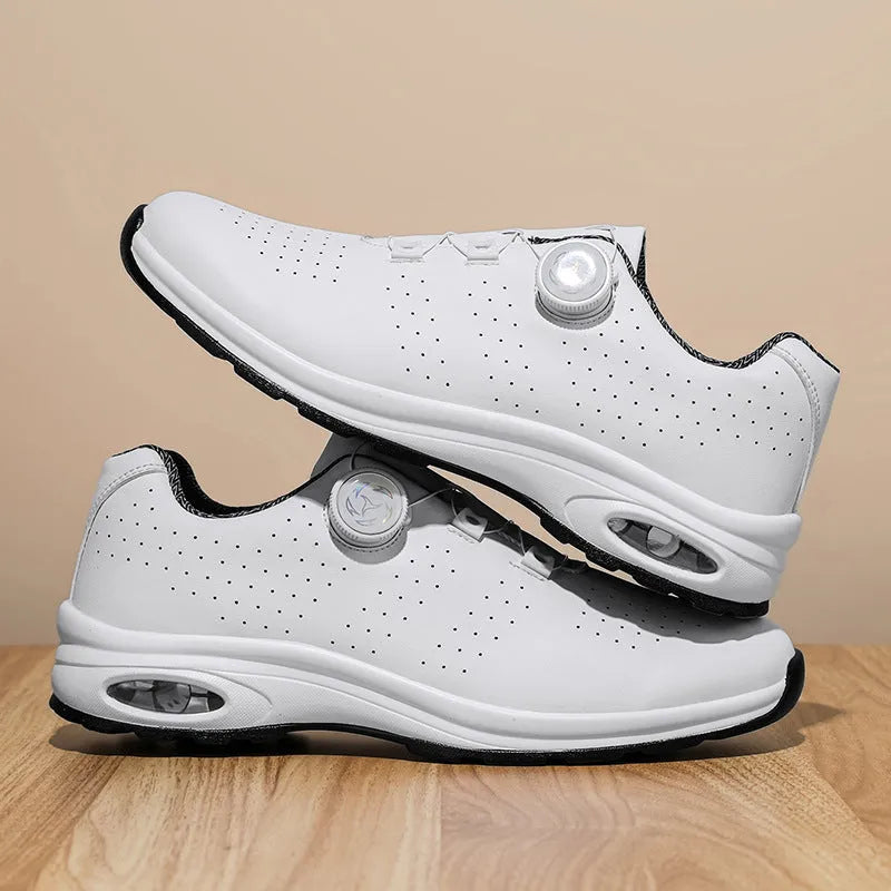 Black and white low-top tennis shoes with mesh upper and composite sole.