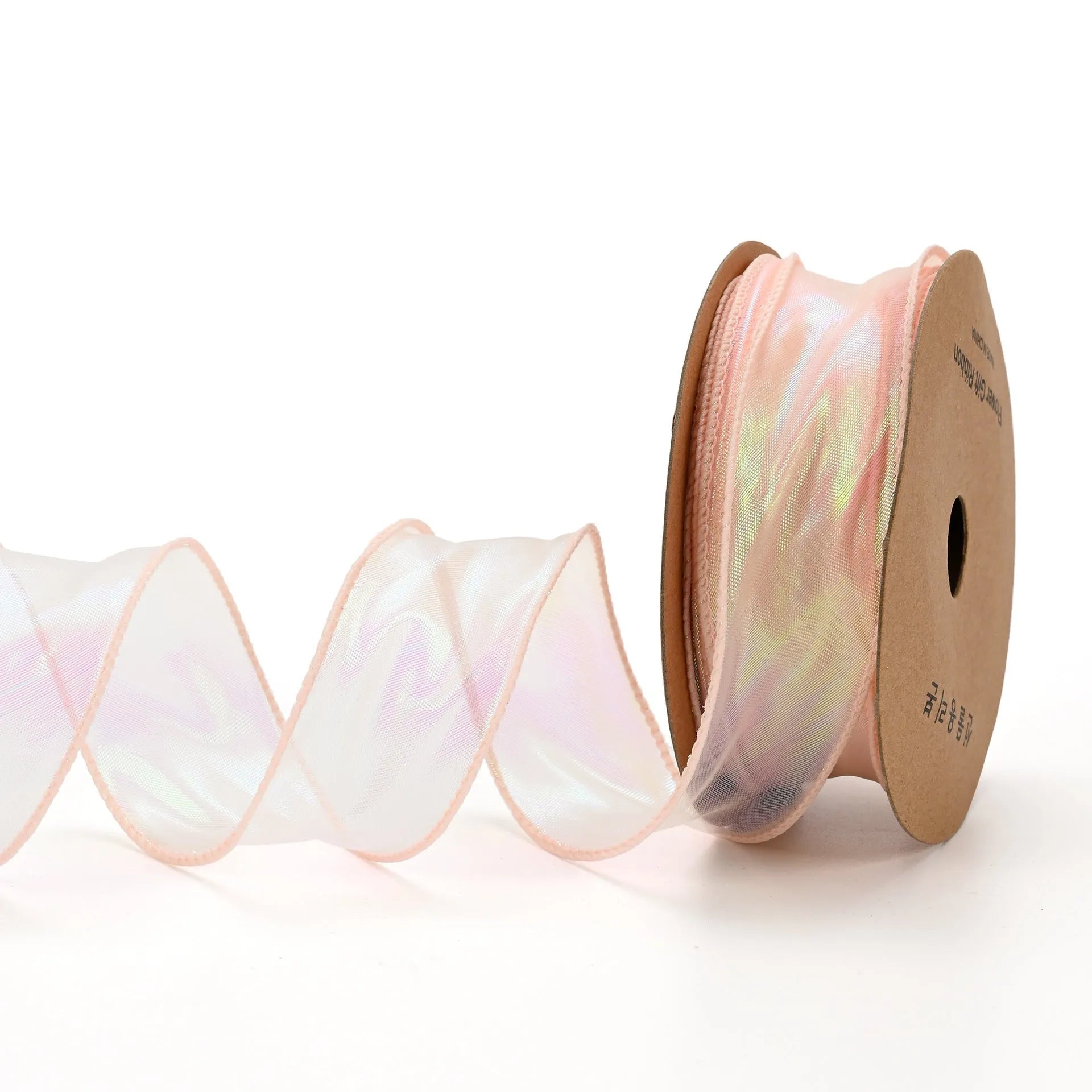 Roll of colourful fishtail yarn mesh ribbon showing its textured, wavy edge, with a colour selection including pink, yellow, and blue.