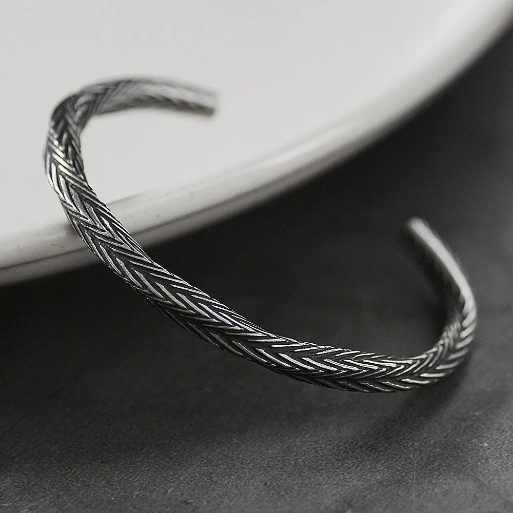 Men's white titanium steel pattern bracelet with geometric design on plain background