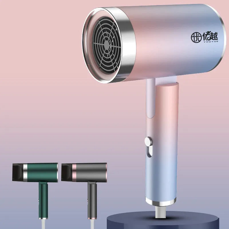 Foldable negative ion hair dryer in emerald green colour with nozzle attached
